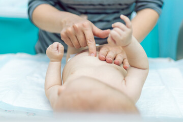 Obraz na płótnie Canvas Baby massage closeup. Mother and child. Newborn.