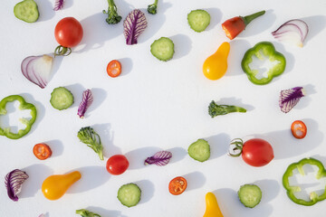 Composition of vegetables, cut for salad on a white plate with space for text . Background with food.