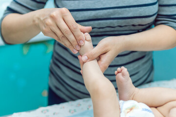 Fototapeta premium Baby massage closeup. Mother and child. Newborn.