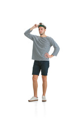 Confident posing. Caucasian male sailor in uniform on white studio background. Young man using modern devices and gadgets in his work. Concept of tech, professional occupation, job of seaman.