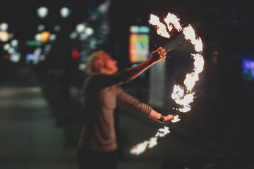 Group of fire artists fakir perform amazing show at night with flamethrowers, fire dancers, chain...