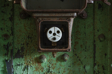 A defunct power outlet mounted on a vertical girder.