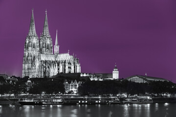 Cologne, Germany. Night View Of Cologne Cathedral. Catholic Gothic Cathedral In Night. UNESCO World Heritage Site. Toned Photo Black, White And Ultra Violet Colors