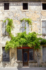 Fototapeta na wymiar A 2020 view of a medieval house with climbing ivy in Lagrasse, South of France.