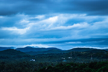 mountain top view of hill range with clouded sky at evening