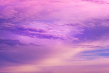 Beautiful pink sky background. Soft clouds at sunset. Many blue, magenta and orange tones and patterns of clouds