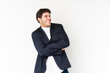 Young business man isolated on white background funny and friendly sticking out tongue.