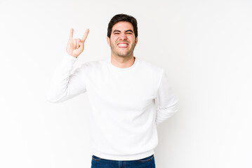 Young man isolated on white background showing rock gesture with fingers