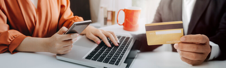 businesswoman hand using smart phone,mobile p payments online shopping,omni channel,digital tablet docking keyboard computer at office in sun light