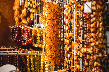 Variety assortment of souvenirs made of amber, traditional tourist souvenirs and gifts from Kaliningrad, Russia, in local vendor souvenir shop