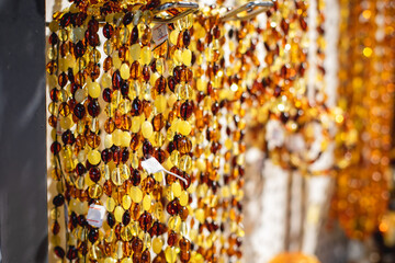 Variety assortment of souvenirs made of amber, traditional tourist souvenirs and gifts from Kaliningrad, Russia, in local vendor souvenir shop