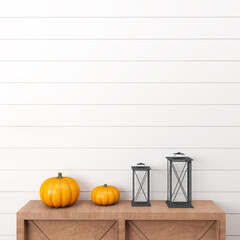 halloween pumpkin on a wooden table in front of a white wall with two black lanterns 
