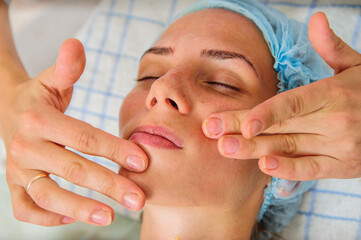 Young and relaxed woman getting a face massage