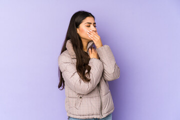 Young indian woman isolated on purple background suffers pain in throat due a virus or infection.