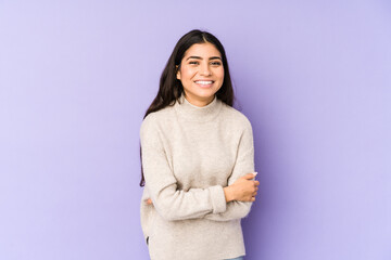 Fototapeta premium Young indian woman isolated on purple background laughing and having fun.