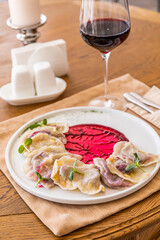 dumplings with cherries. Traditional Ukrainian dish. Decorated with mint leaves.