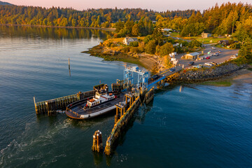 Overhead Aerial View of a Small Ferryboat docking on Lummi Island. The 21 car ferry services this small island near the city of Bellingham in the Salish Sea area of the Pacific Northwest.