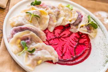 dumplings with cherries. Traditional Ukrainian dish. Decorated with mint leaves.