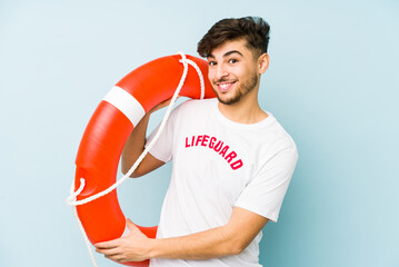 Young arabian lifeguard man isolated  laughing and having fun.