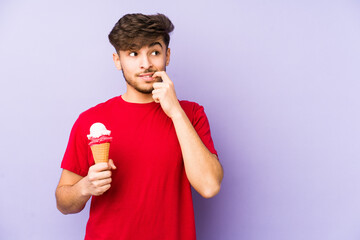 Young arabian man holding a ice cream relaxed thinking about something looking at a copy space.