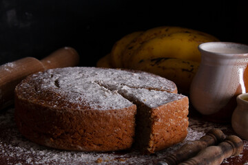 Homemade banana or plantain cake portioned in a circular shape sprinkled with glass sugar flat frontal