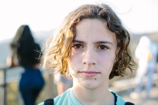Portrait of a young teen girl outside with a serious expression