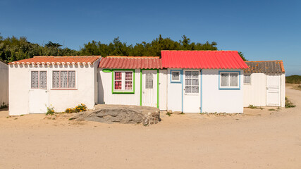 Yeu island in France, colorful huts on the beach