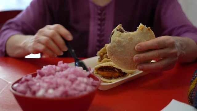 Closeup of gorditas on a plate. This Mexican specialty uses pork and onions on corn.