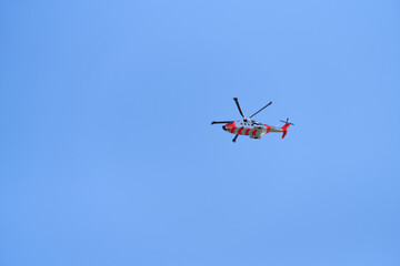 Fototapeta na wymiar Rescue helicopter above Oslo's garden suburbs. The image has large copy space