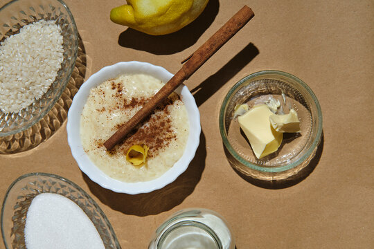 rice pudding with its ingredients on a brown background
