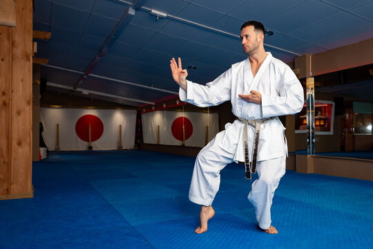 Karate man stand your ground on tatami doing "Shuto uke"
