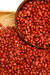 Fresh red peanuts in wooden bowl.