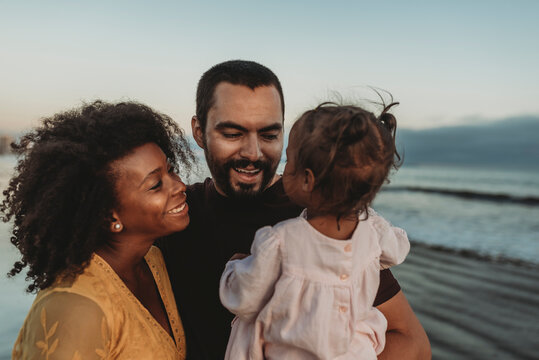 Young family embracing at the beach