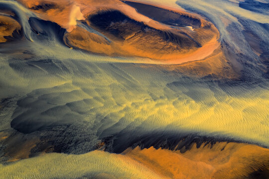 Colorful glacier rivers on the south coast of Iceland with black sand