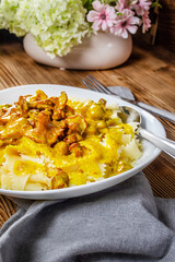 Pasta with fried chicken in cream and chanterelle sauce.