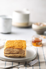 Delicious slice of homemade honey cake on white background.