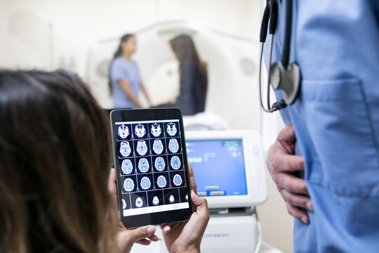 Clinic: Scan Techs Look At Test Results On Tablet