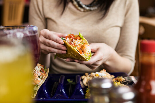 Cinco: Anonymous Woman Holding Shrimp Taco In Fried Shell