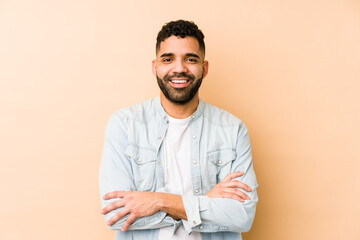 Young mixed race arabic man isolated who feels confident, crossing arms with determination.