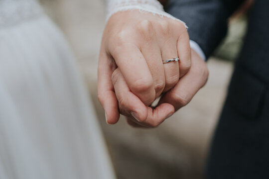 Newlywed couple holding hands