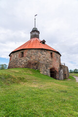 Fototapeta premium Old fortress tower near river