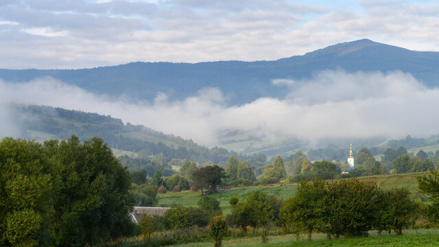 Traditional swiss early autumn view of misty morning in the mountains