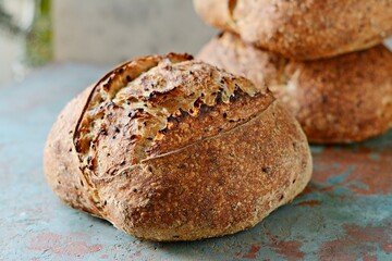 Homemade Freshly Baked Country Bread  made from wheat and whole grain flour on gray background. French Freshly baked bread. 