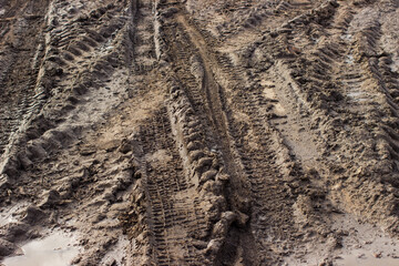 Dirty road with mud and puddles and truck wheel tracks after rain. Off-road. The background.
