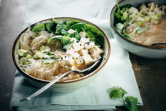 Food. Asian rice noodle soup with baby spinach, tofu and onions