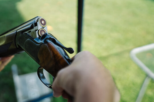 Mid Adult Man Training His Aim and Concentration Using a Shotgun in a Clay Pigeon Shooting Field Sport Centre