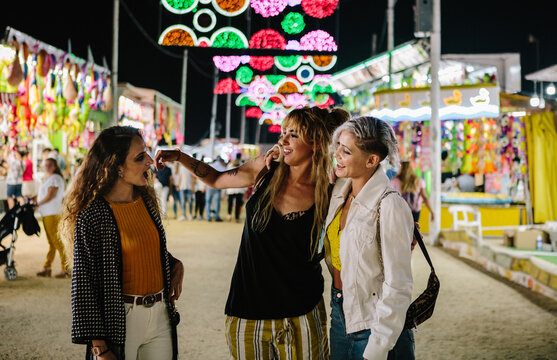 three women talking in the funfair