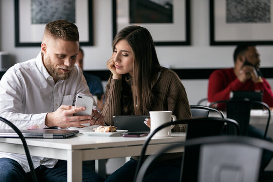 Business: Man Shows Wife Cell Phone Text