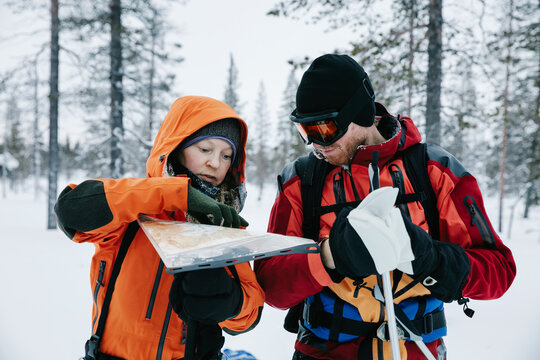 Two Skiers Reading Map