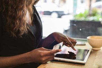 Woman using a credit card for shopping online